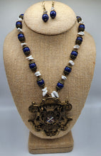 Load image into Gallery viewer, Vintage Lapis and Howlite Gemstone Braided Necklace and Earring Set With Coat of Arms Pendant - Trimmed in Antique Gold Findings With Bronze Colored Crystal Accents
