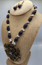 Load image into Gallery viewer, Vintage Lapis and Howlite Gemstone Braided Necklace and Earring Set With Coat of Arms Pendant - Trimmed in Antique Gold Findings With Bronze Colored Crystal Accents
